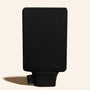 Black mitt with a brand tag on a beige background