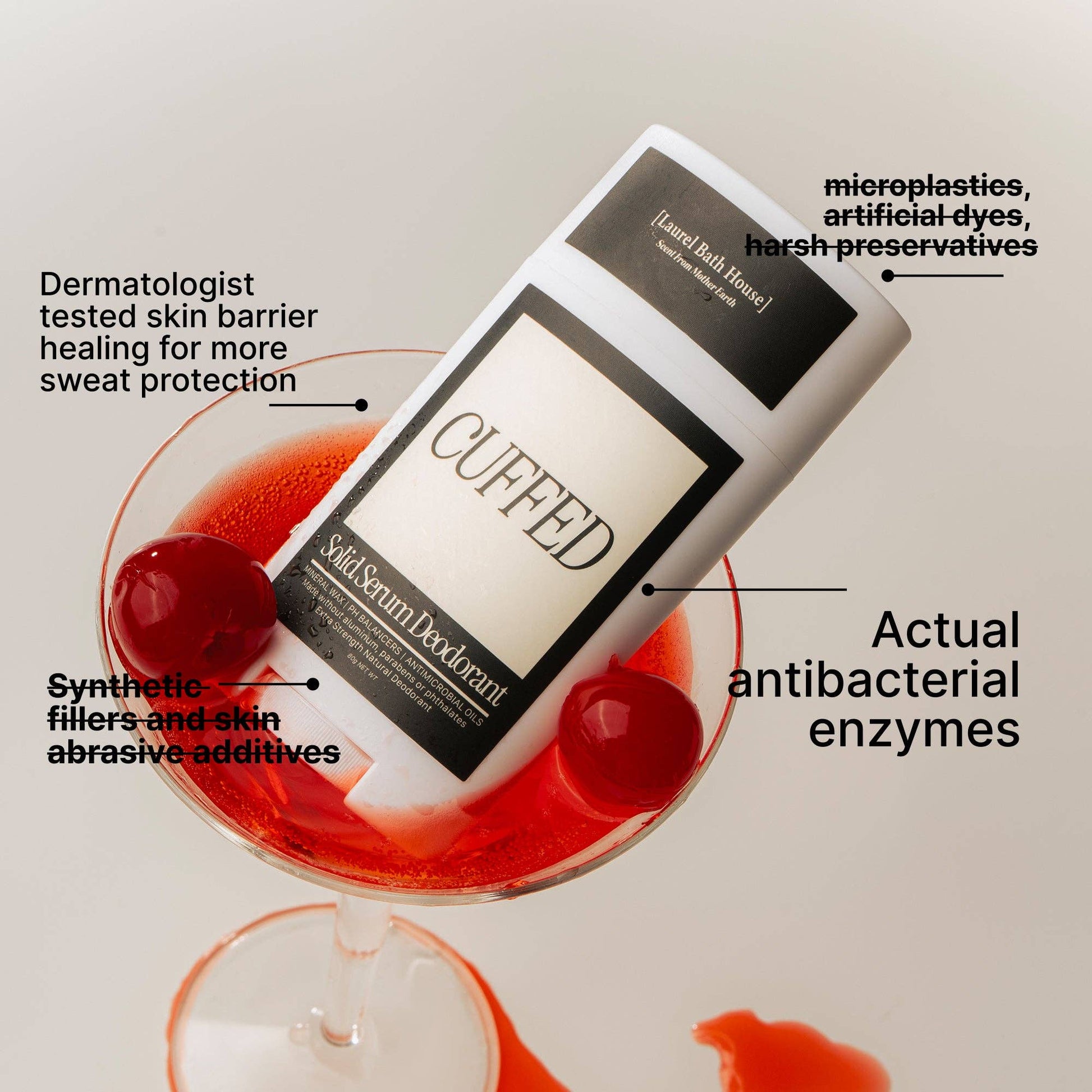 Cuffed solid serum deodorant in a glass with red liquid and cherry, labeled with product features.