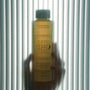 Bottle of 'Cuffed' body wash held against a striped background