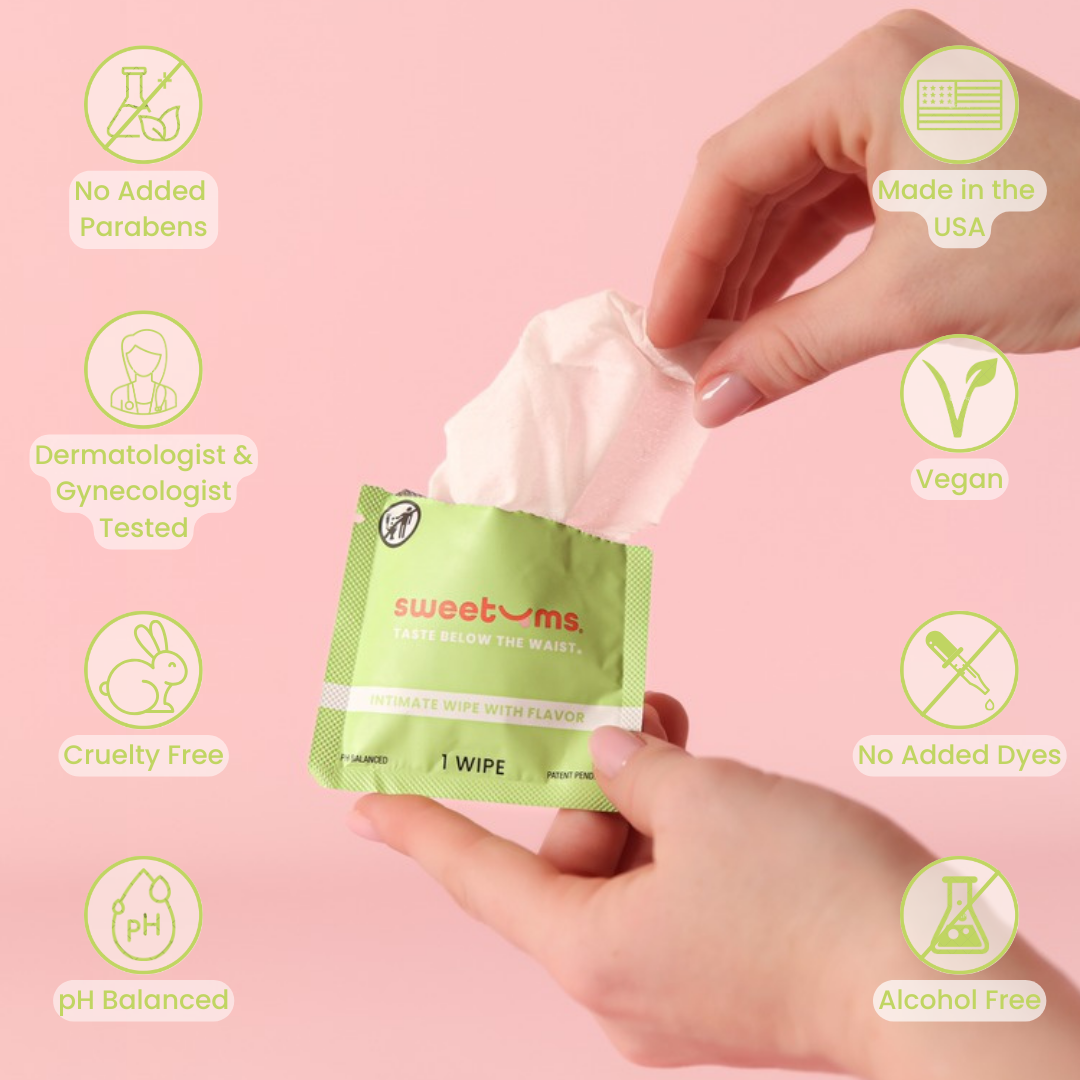 Hand holding a 'sweetums' wipe with product features highlighted on a pink background