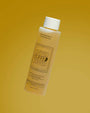 Bottle of 'Cuffed' product on a yellow background