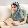 Woman reading a book on a couch with a satin blue bonnet