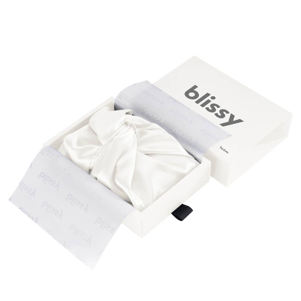 White bonnet with inside a box, branded 'blissy', on a white background