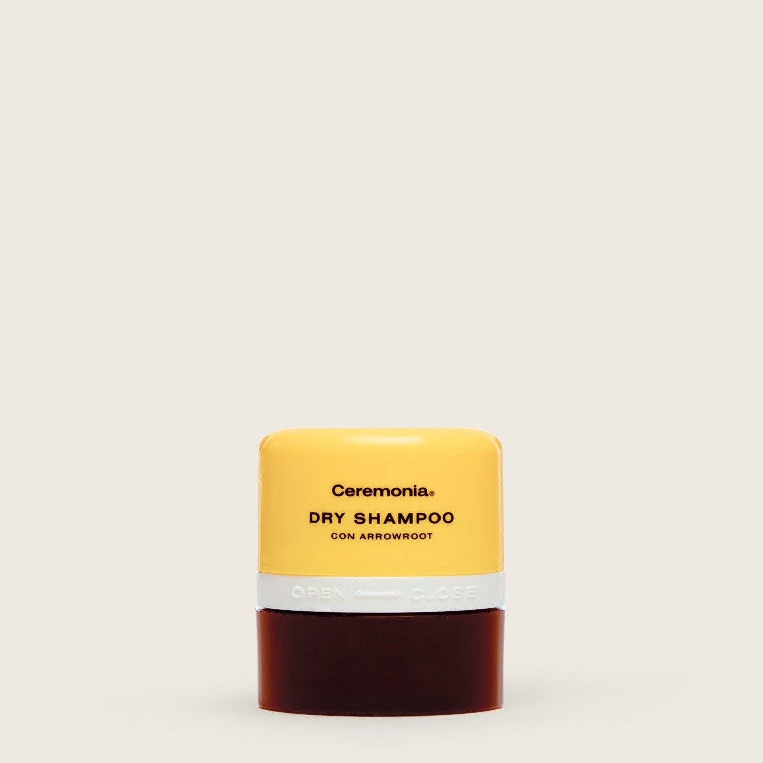 Ceremonia dry shampoo bar with yellow top and brown bottom on a white background