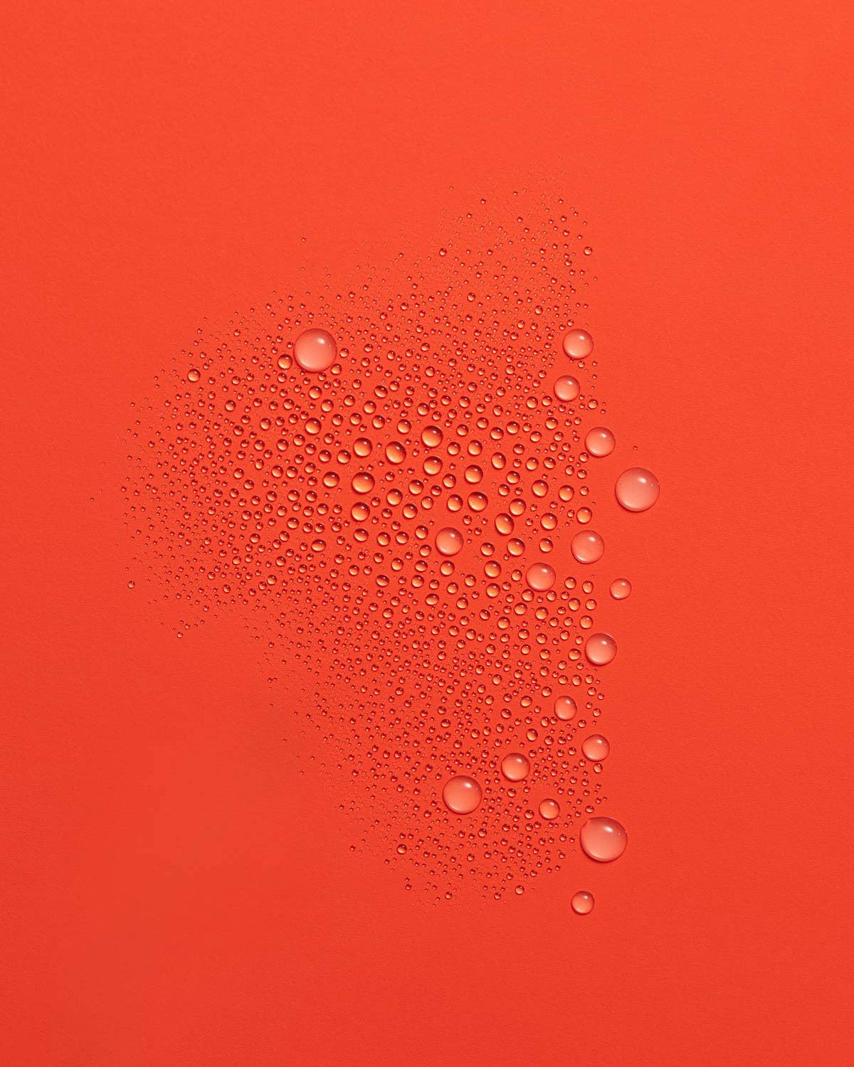 Water droplets on a red surface