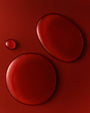Three red circular objects on a red background