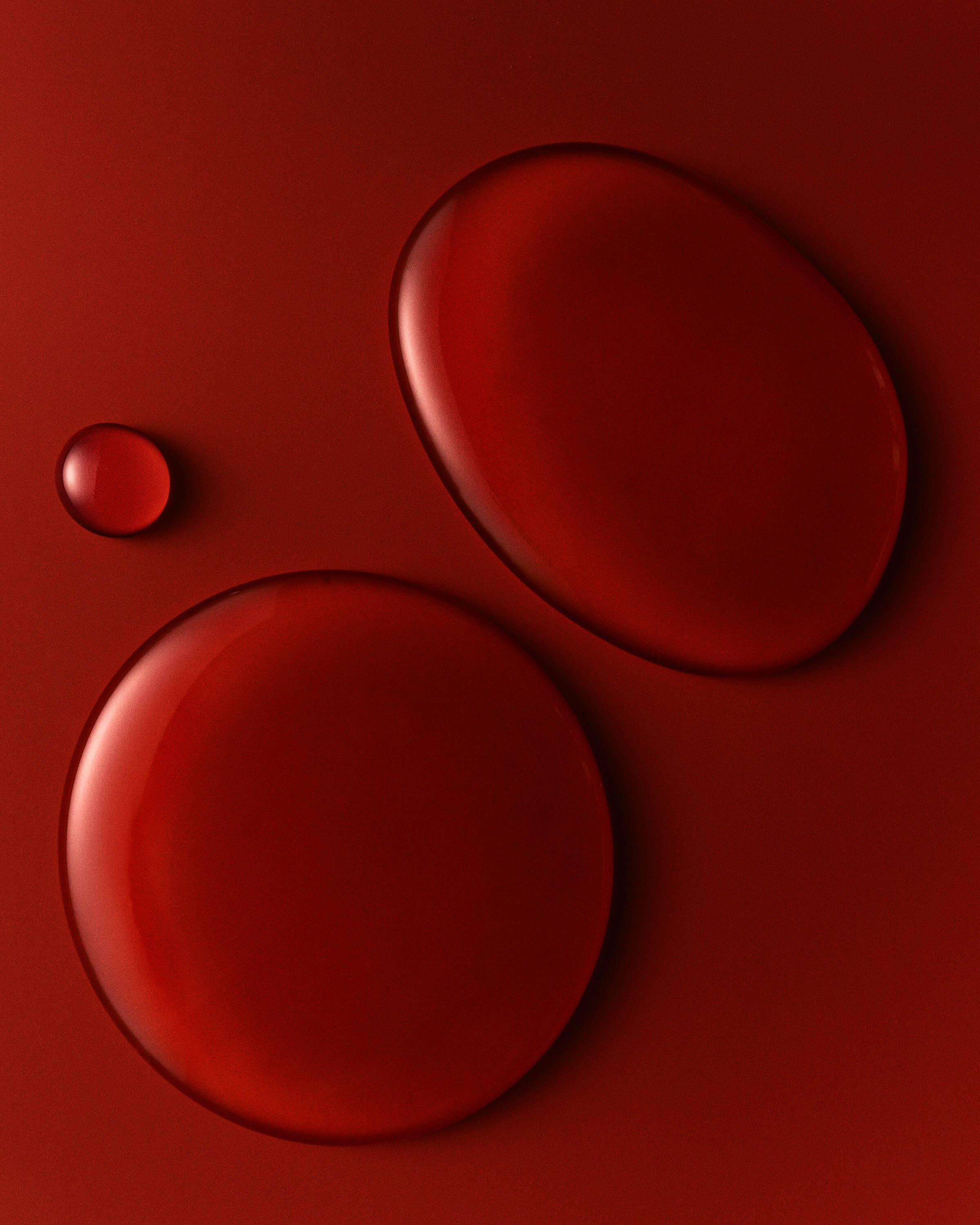 Three red circular objects on a red background