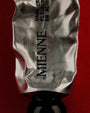 Silver tube with 'MIENNE' branding on a red background