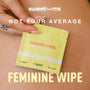 Yellow feminine wipe package with 'sweetums' branding held by a hand on skin background.