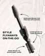 Mascara brush with labeled functions on a textured white background. Labels describe which brush to use to achieve a certain hair style. 