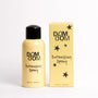A bottle and box of DOM DOM Detangling Spray in a pale yellow color with black text and star graphics, set against a plain white background.