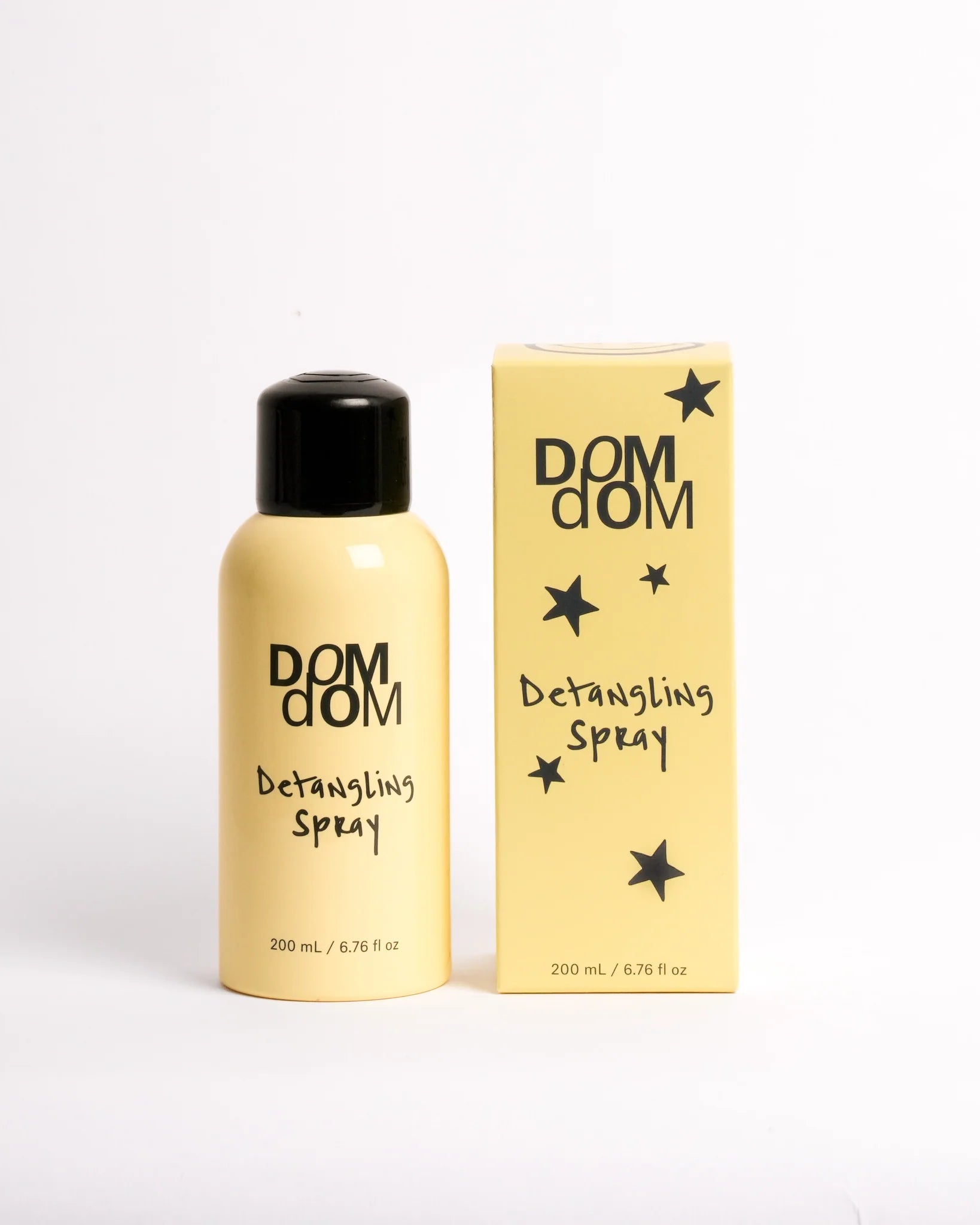 DOM DOM detangling spray bottle and packaging on a white background