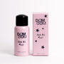 A pink bottle of DOM DOM Hair Oil Mist with a black cap stands next to its matching pink packaging box on a clean white background.