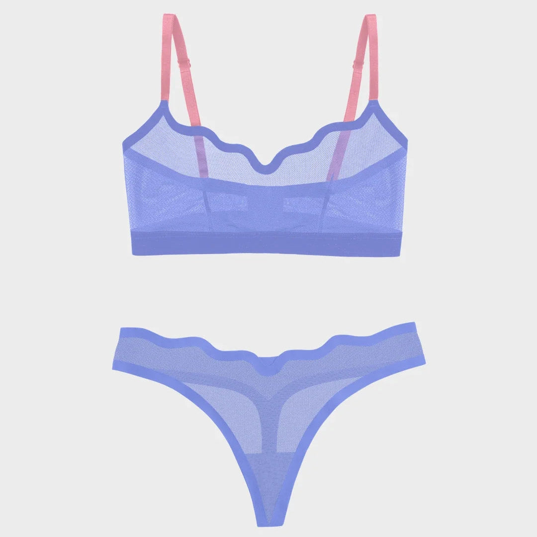 A two-piece sheer lingerie set featuring a lavender-blue mesh bralette with pink straps and matching high-waisted thong bottoms, shown on a light gray background.
