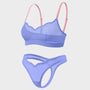 A two-piece women's lingerie set featuring a sheer mesh bralette in light purple with pink straps, and a matching low-rise thong in the same light purple mesh fabric, shown against a solid light gray background.