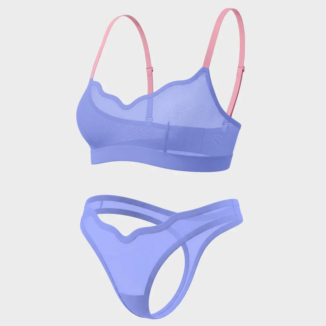 A two-piece women's lingerie set featuring a sheer mesh bralette in light purple with pink straps, and a matching low-rise thong in the same light purple mesh fabric, shown against a solid light gray background.