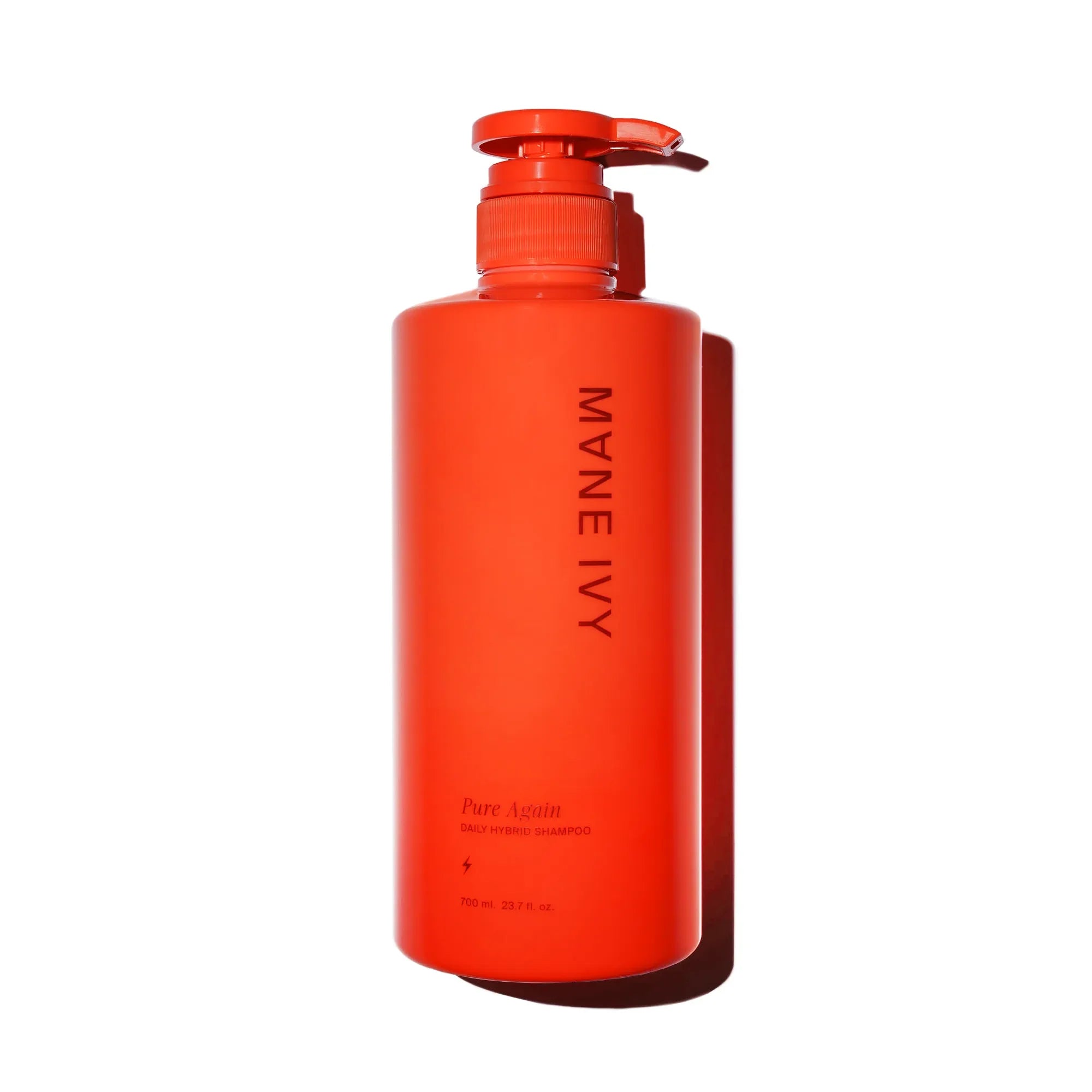 Red shampoo bottle with pump labeled 'MYNE IVY' on a white background