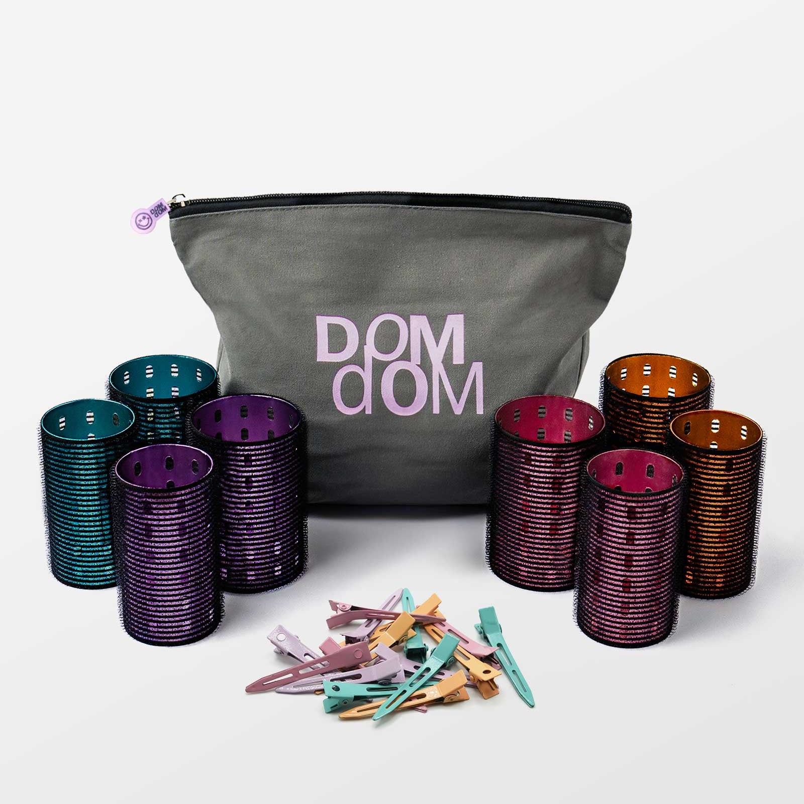 Set of hair curlers and clips with a DOM DOM branded bag on a white background