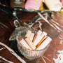 chapstic in glass bowl against a marble backgorund