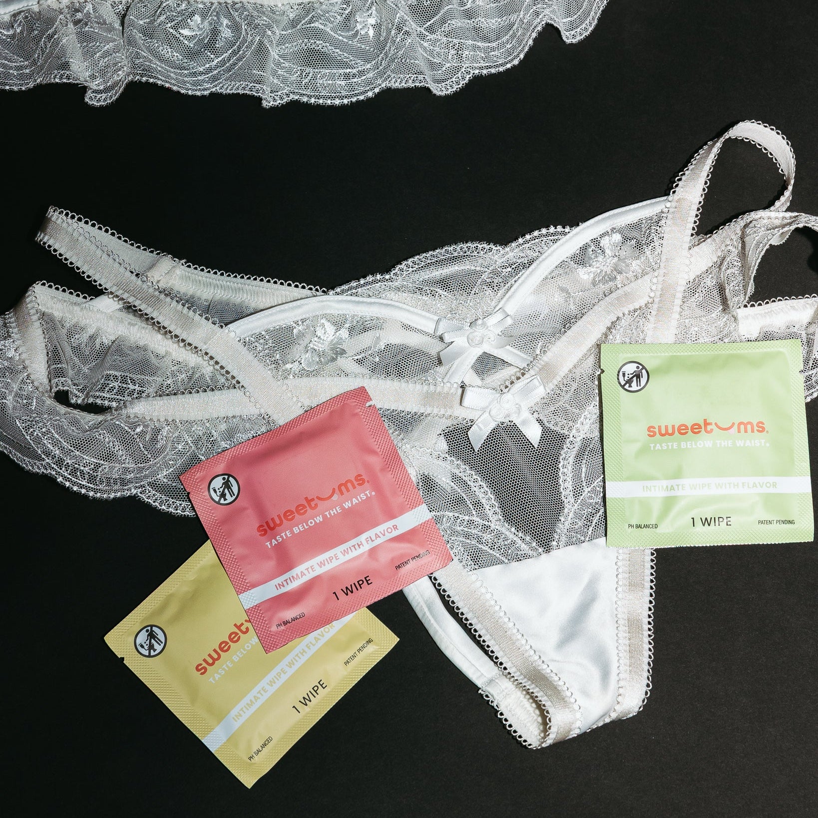 lingerie with sweetums packs on a black background