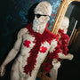 Statue with red cloths and sunglasses in a decorative room with a mirror.
