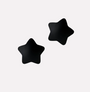 Black star-shaped pasties on a light gray background