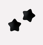 Black star-shaped pasties on a light gray background