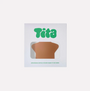 Tita brand packaging with a brown star nipple cover inside on a white background