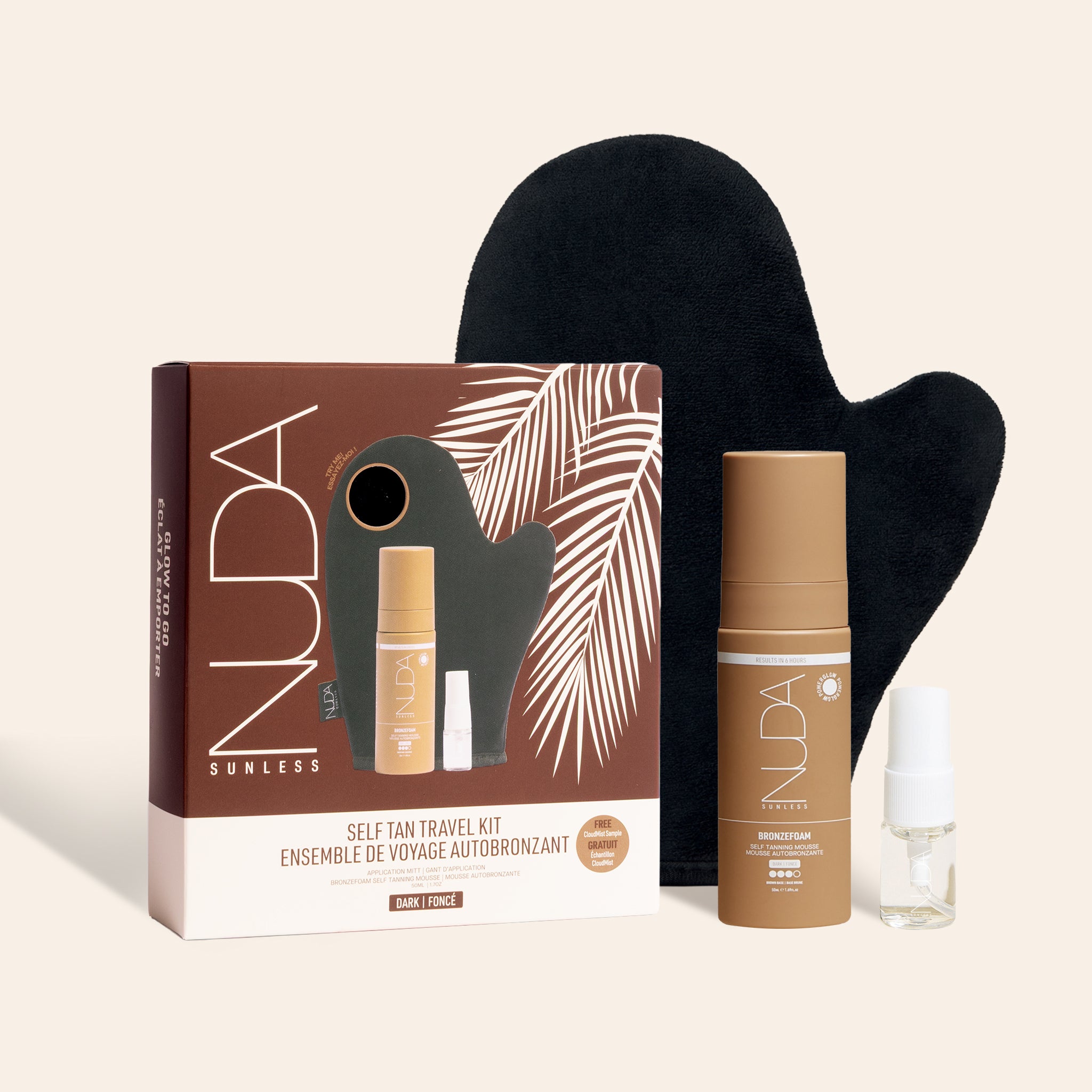 Nuda self-tan travel kit with packaging, mitt, and bottles on a beige background