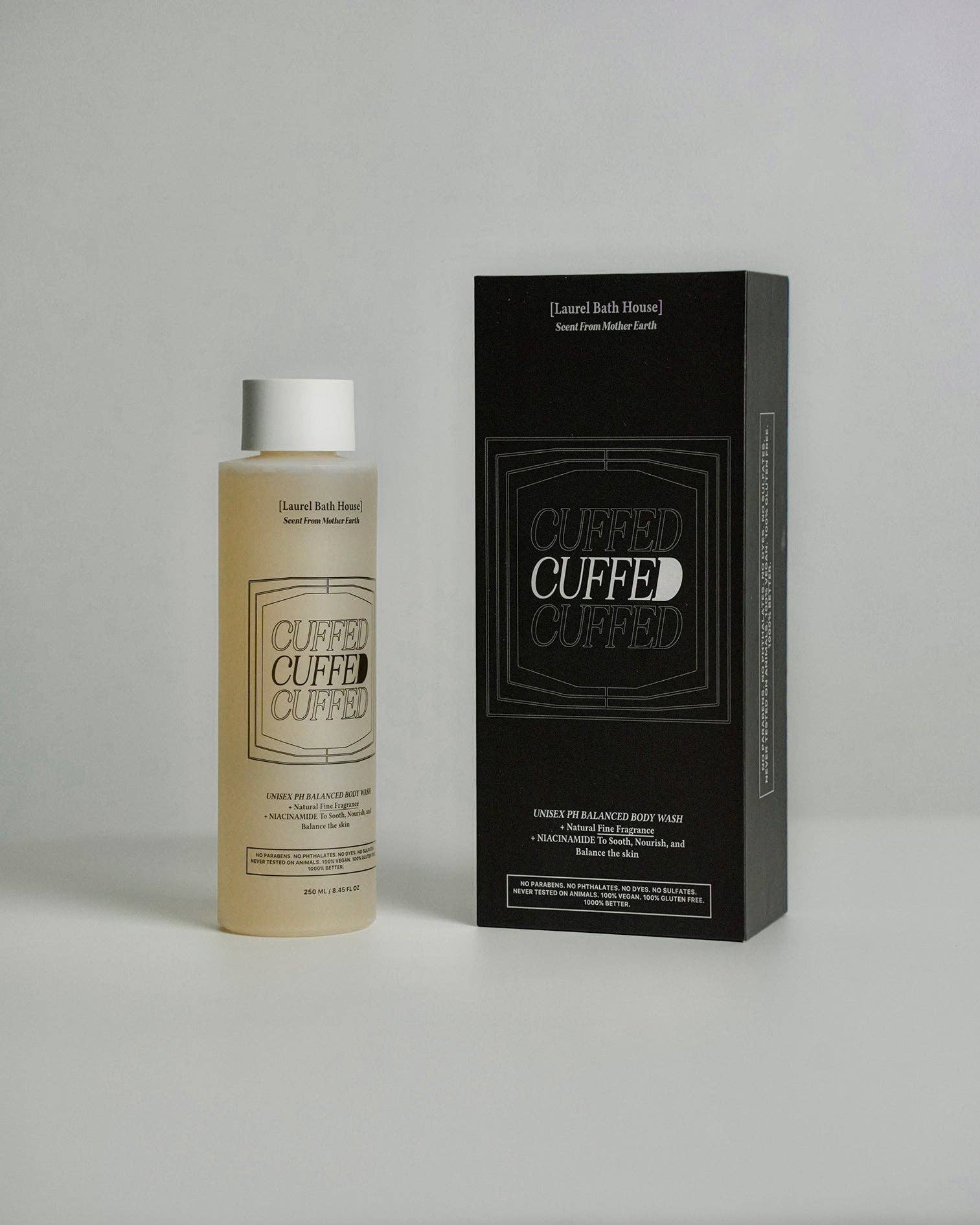 Cuffed bath product bottle and packaging on a gray background