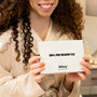 Woman holding a Blissly product packaging with '100% Pure Mulberry Silk' text.