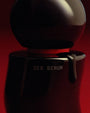 Black container labeled 'SEX SERUM' on a red background