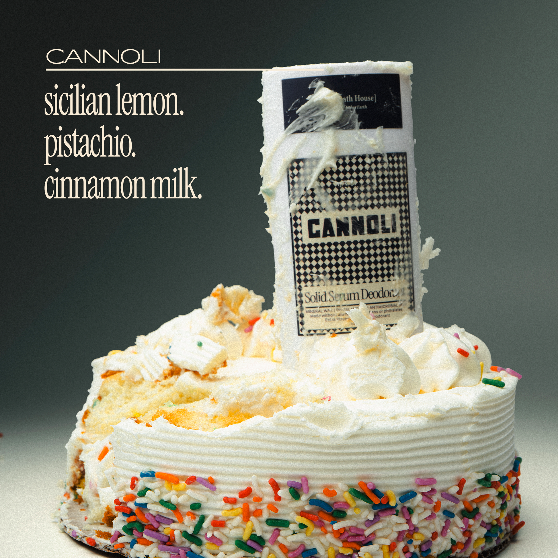 Decorative cake with colorful sprinkles and a cannoli flavor label on a dark background