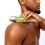 Man holding a green spray bottle to his shoulder on a white background