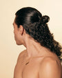 Man with styled hair on a beige background