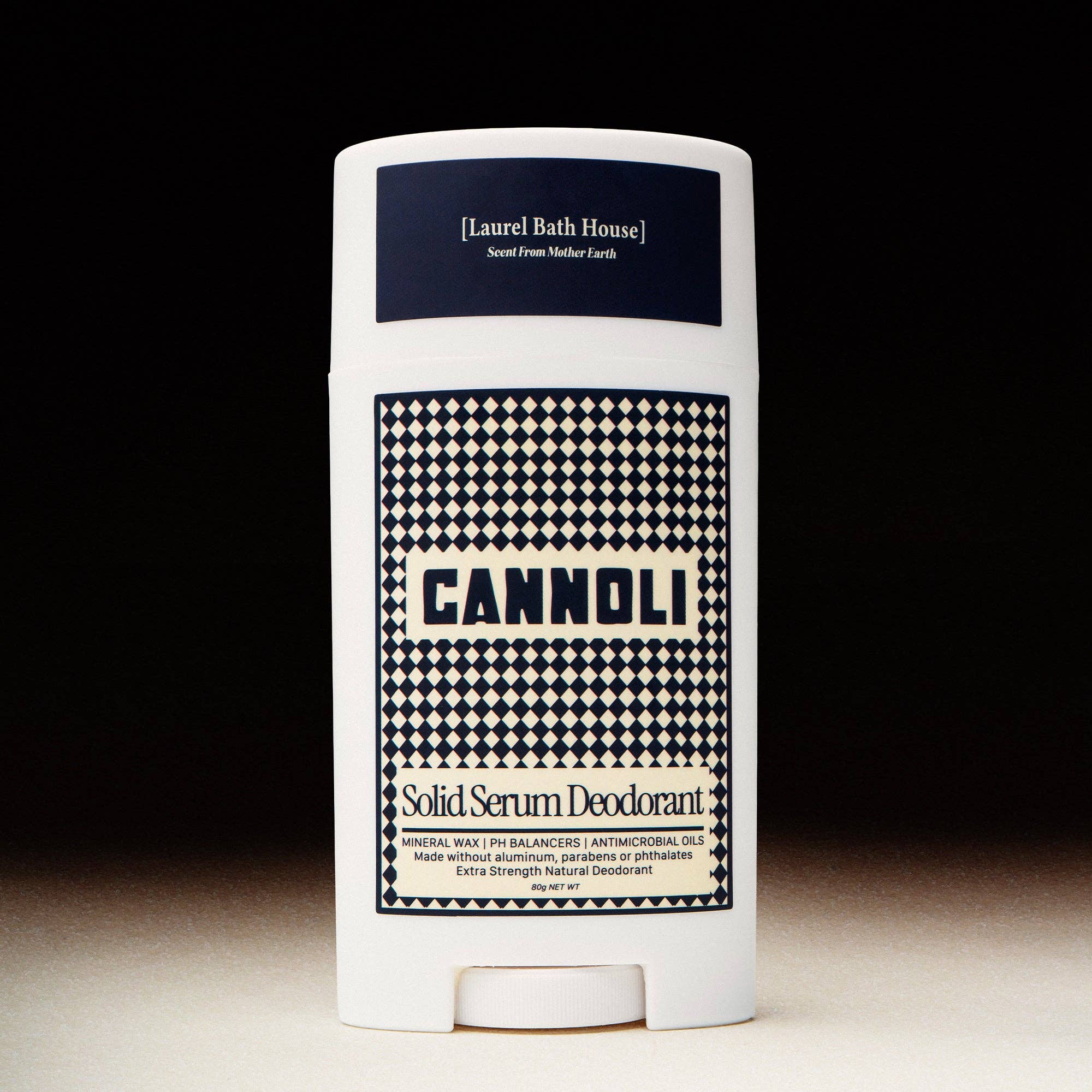 Cannoli solid serum deodorant with checkered pattern on a black background
