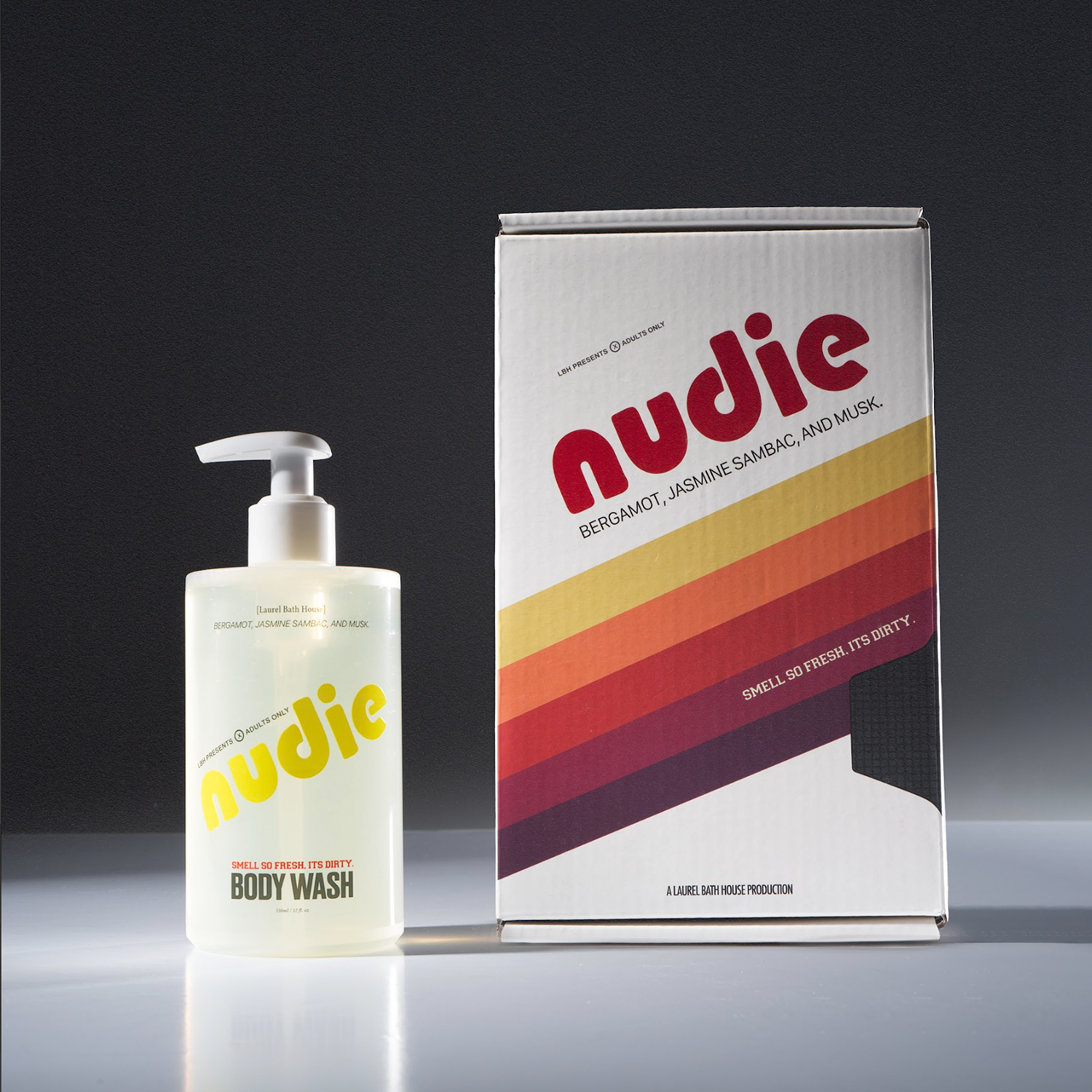 Nudie body wash bottle and packaging on a gradient background