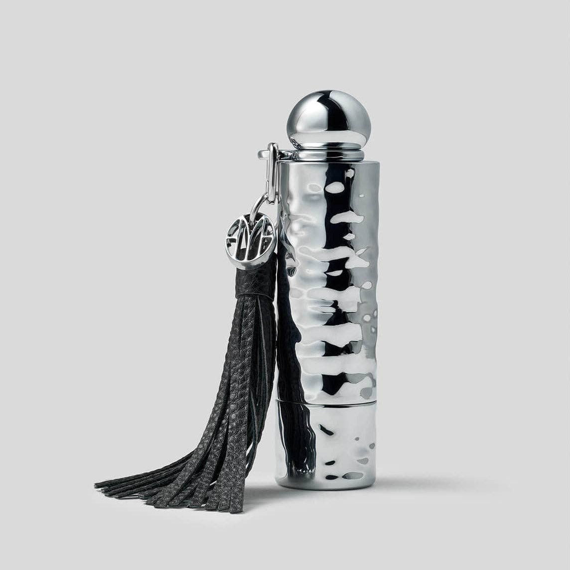 Silver textured bottle with black tassel on a light gray background