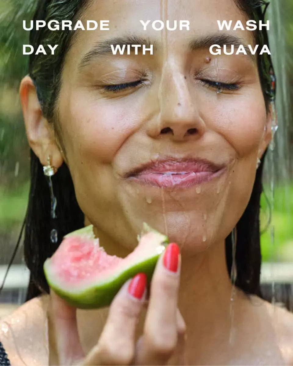 Woman eating watermelon with water running down her face. Words saying Upgrade Your Wash Day with Guava'.