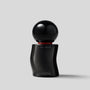 Black serum bottle with spherical cap on a light gray background